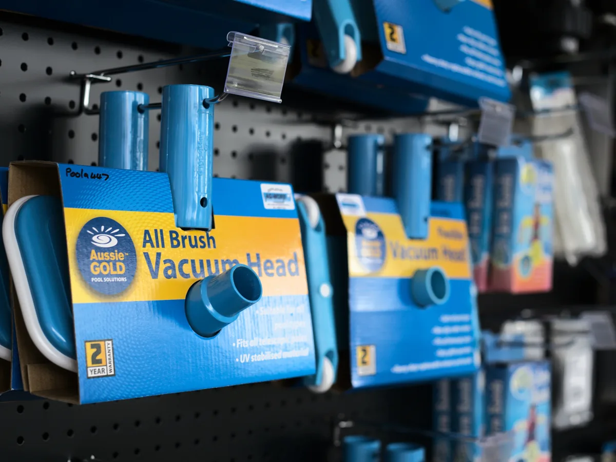 Pool vacuum heads hanging on the accessory wall